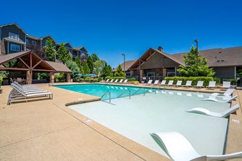 Outdoor pool with tanning shelf